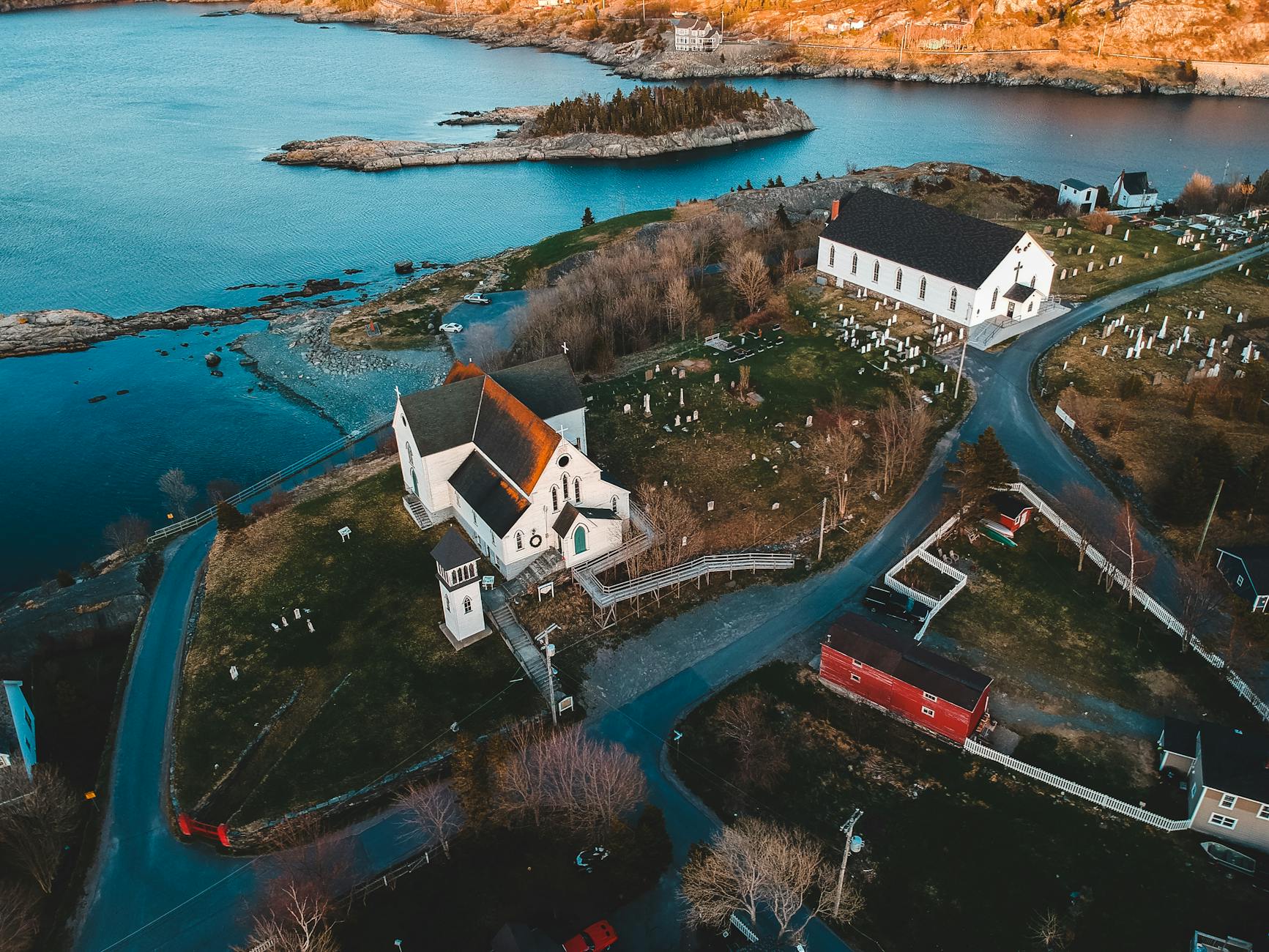 old church and buildings on hill near cemetery and river